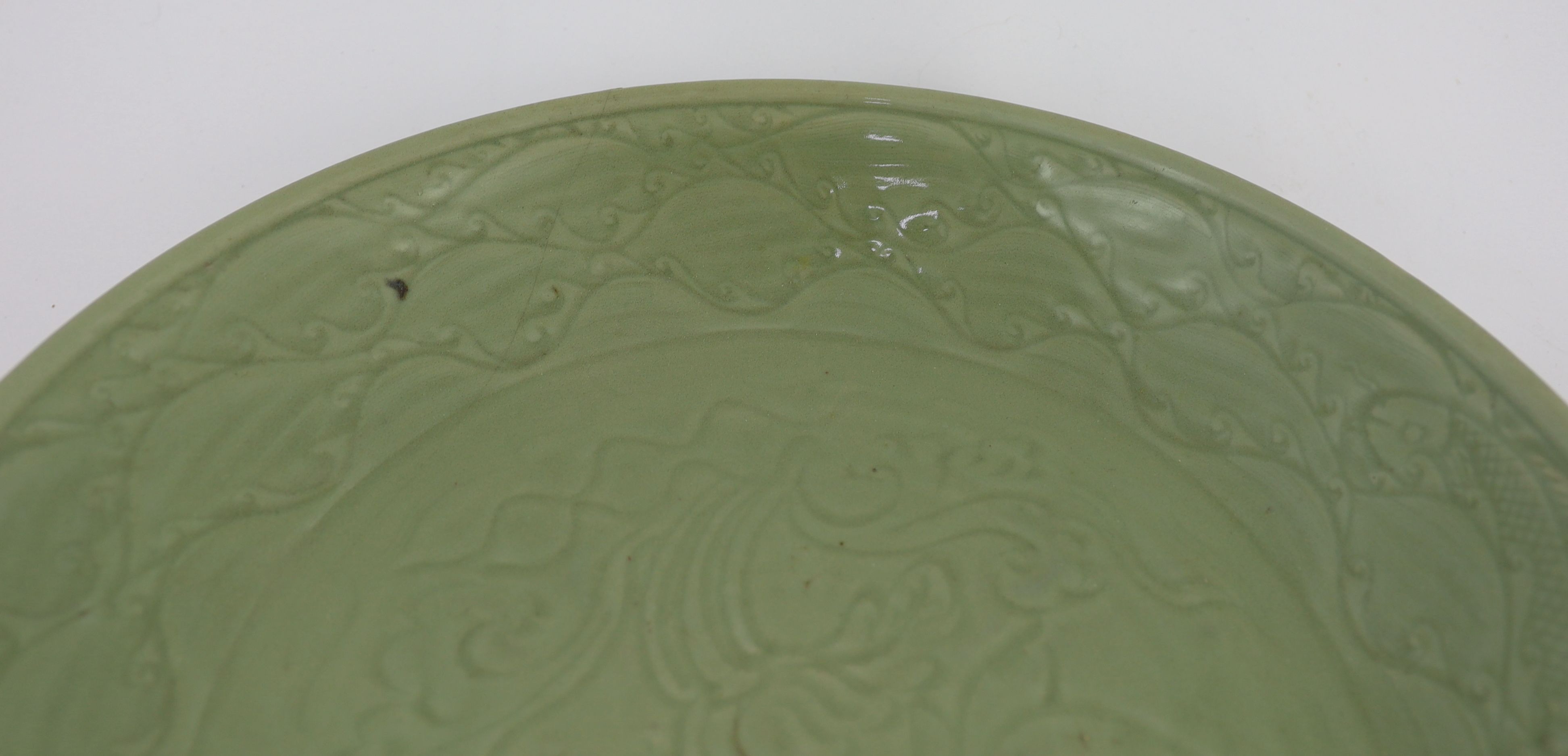 A rare large Chinese Ming Longquan celadon dish, 14th century, 44 cm diameter, Broken and restored